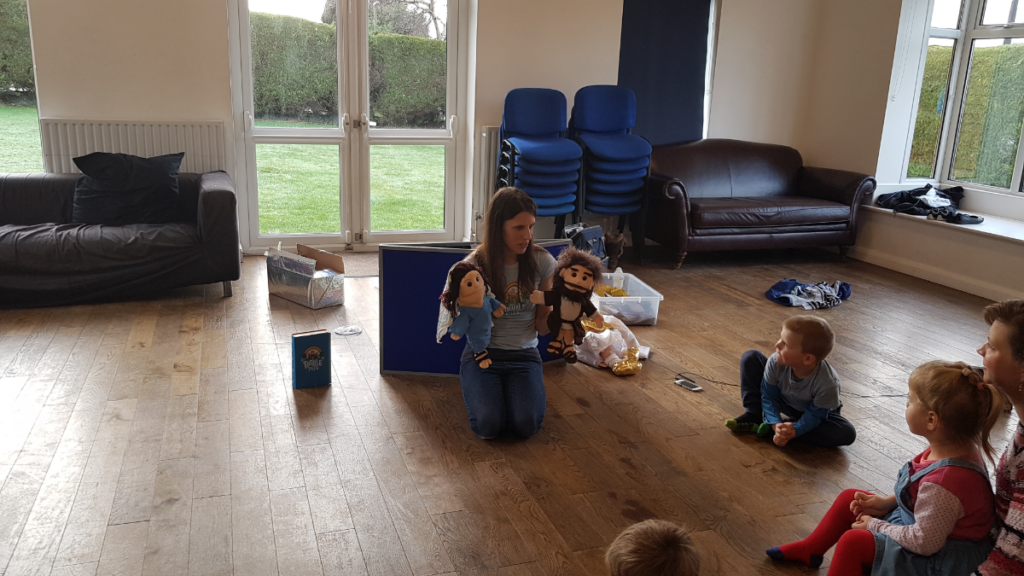 Lauren teaching Bible stories for children using Mary and Joseph.